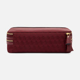Anya Hindmarch Logo Make-Up Pouch in burgundy with a repeating geometric pattern, gold zipper, and leather tassel pull.