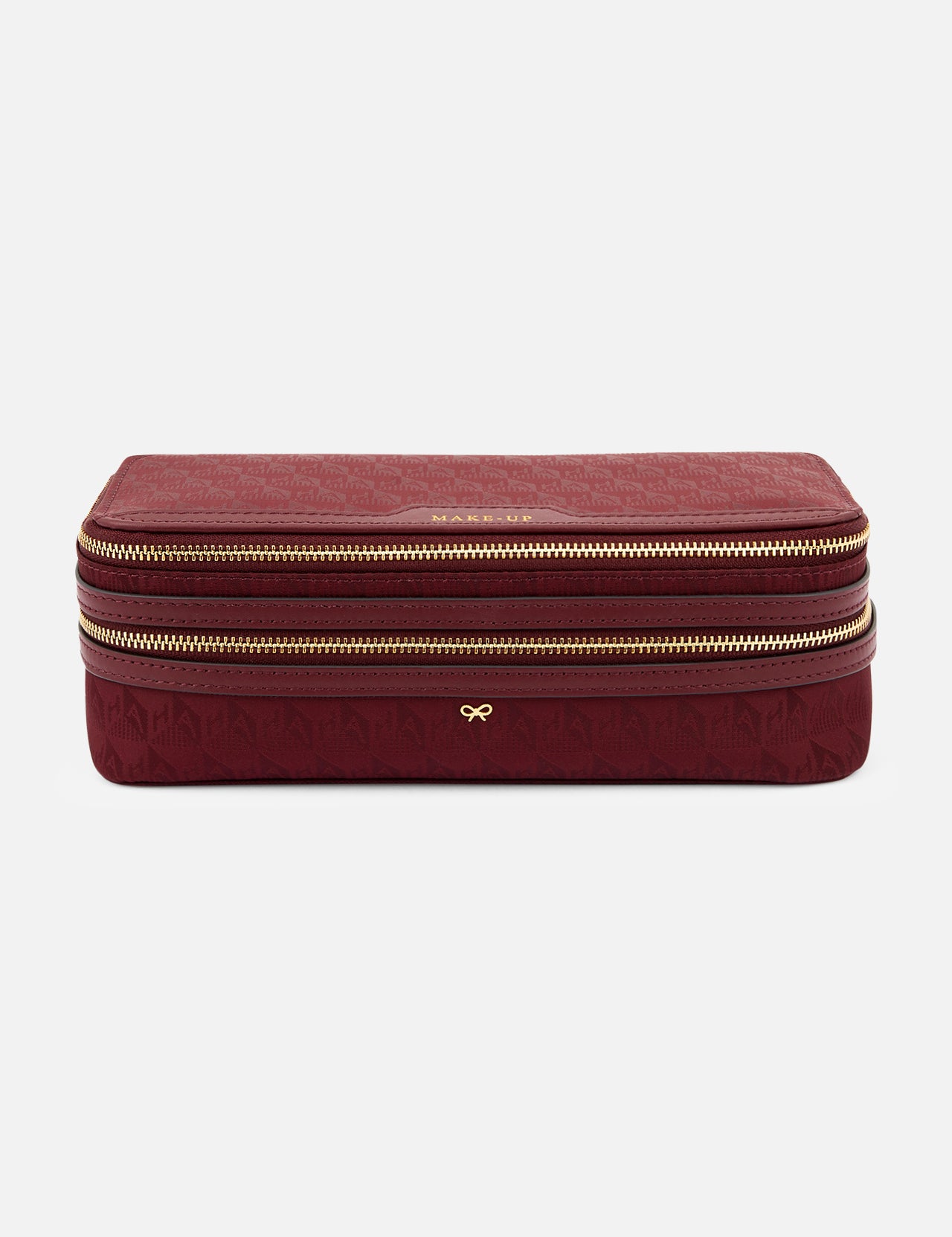 Burgundy rectangular Anya Hindmarch Logo Make-Up Pouch with two gold zippers, organizational compartments, and a gold bow emblem on the front.