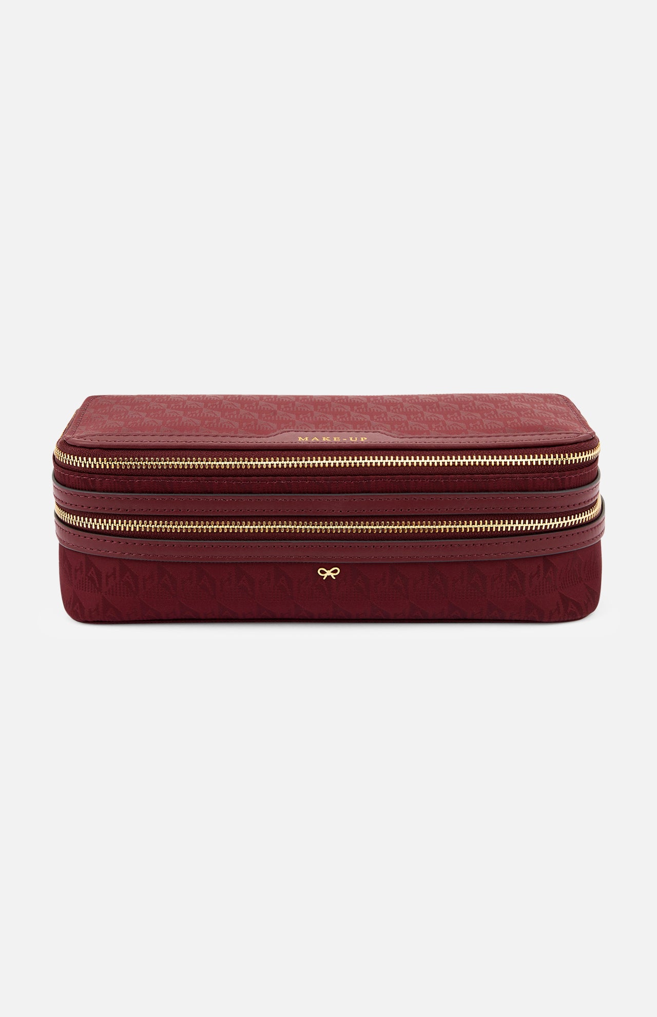 Burgundy rectangular Anya Hindmarch Logo Make-Up Pouch with two gold zippers, organizational compartments, and a gold bow emblem on the front.