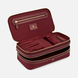 Open burgundy Anya Hindmarch Logo Make-Up Pouch revealing internal elastic brush holders and a zippered pocket, crafted with Italian organizational compartments.