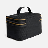 Anya Hindmarch Logo Vanity Kit, a black structured vanity case with a top handle and two gold-tone wrap-around zippers.