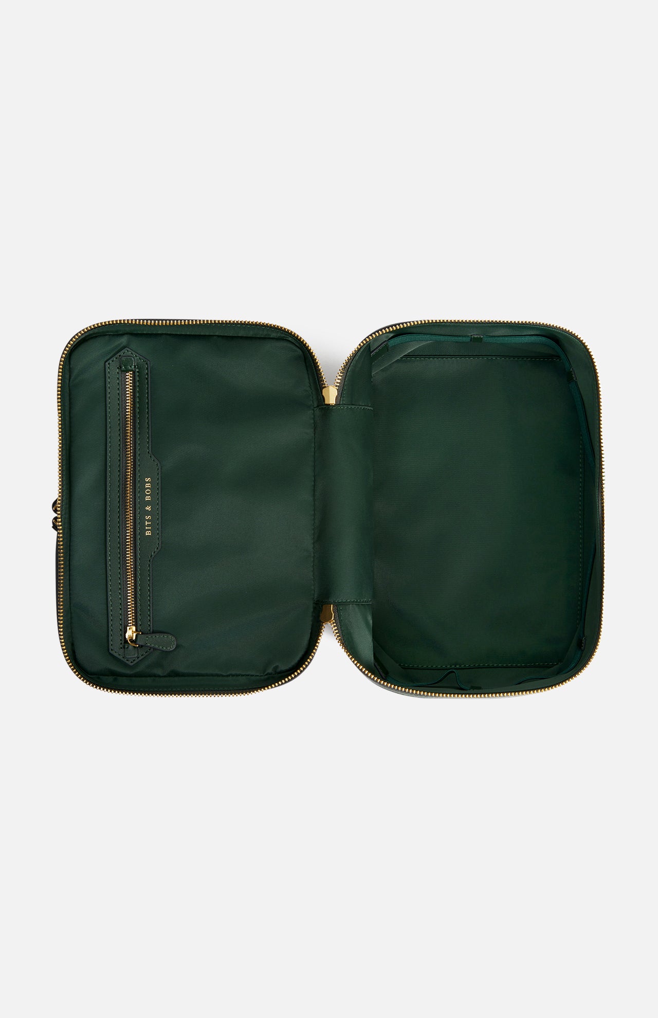 Open dark green Anya Hindmarch Logo Vanity Kit with a zippered closure and a small interior pocket labeled BITS & BOBS on the left flap.