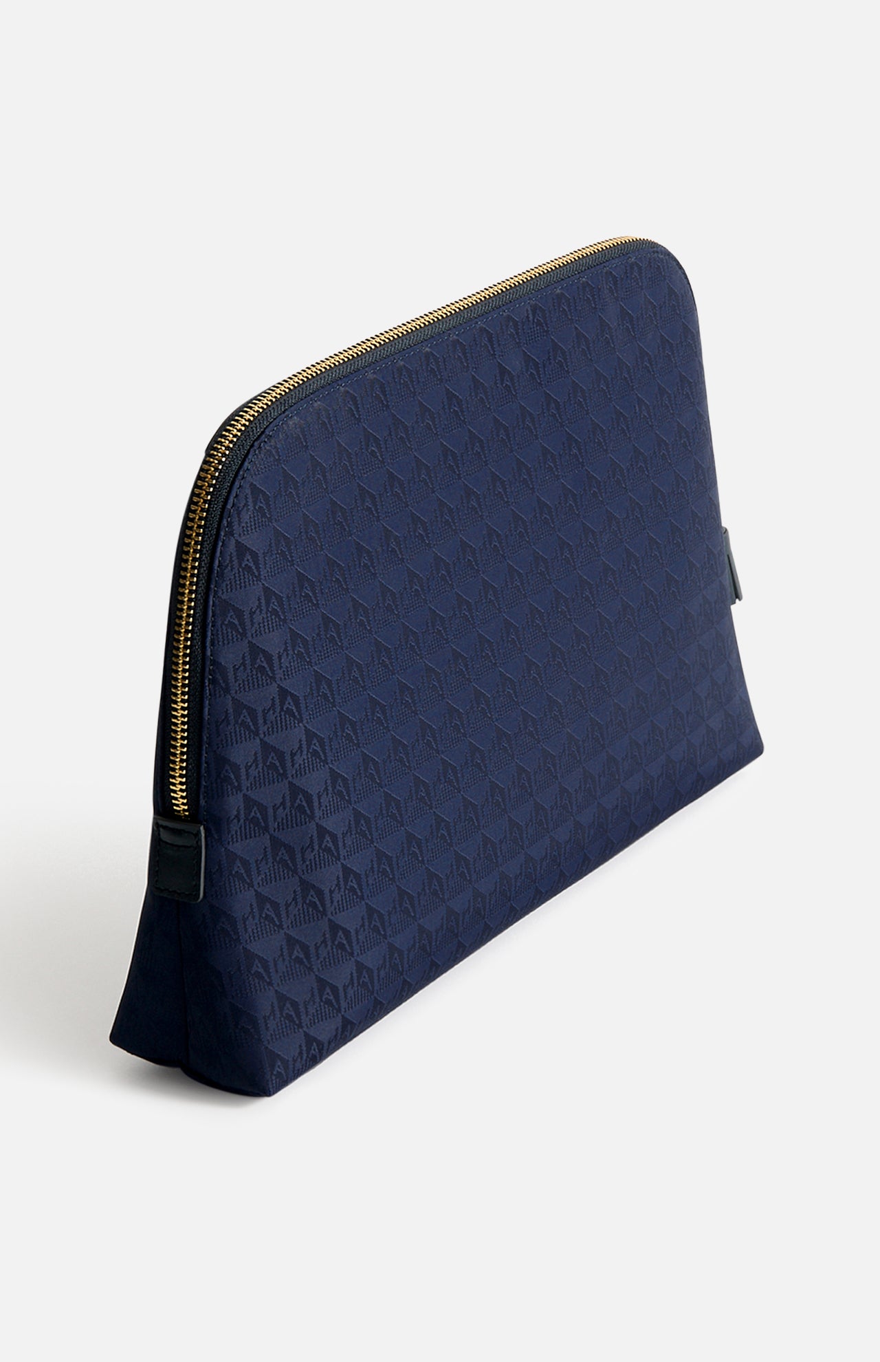 Anya Hindmarch Lotions and Potions Pouch in navy blue with a repeating geometric pattern and gold-tone hardware.