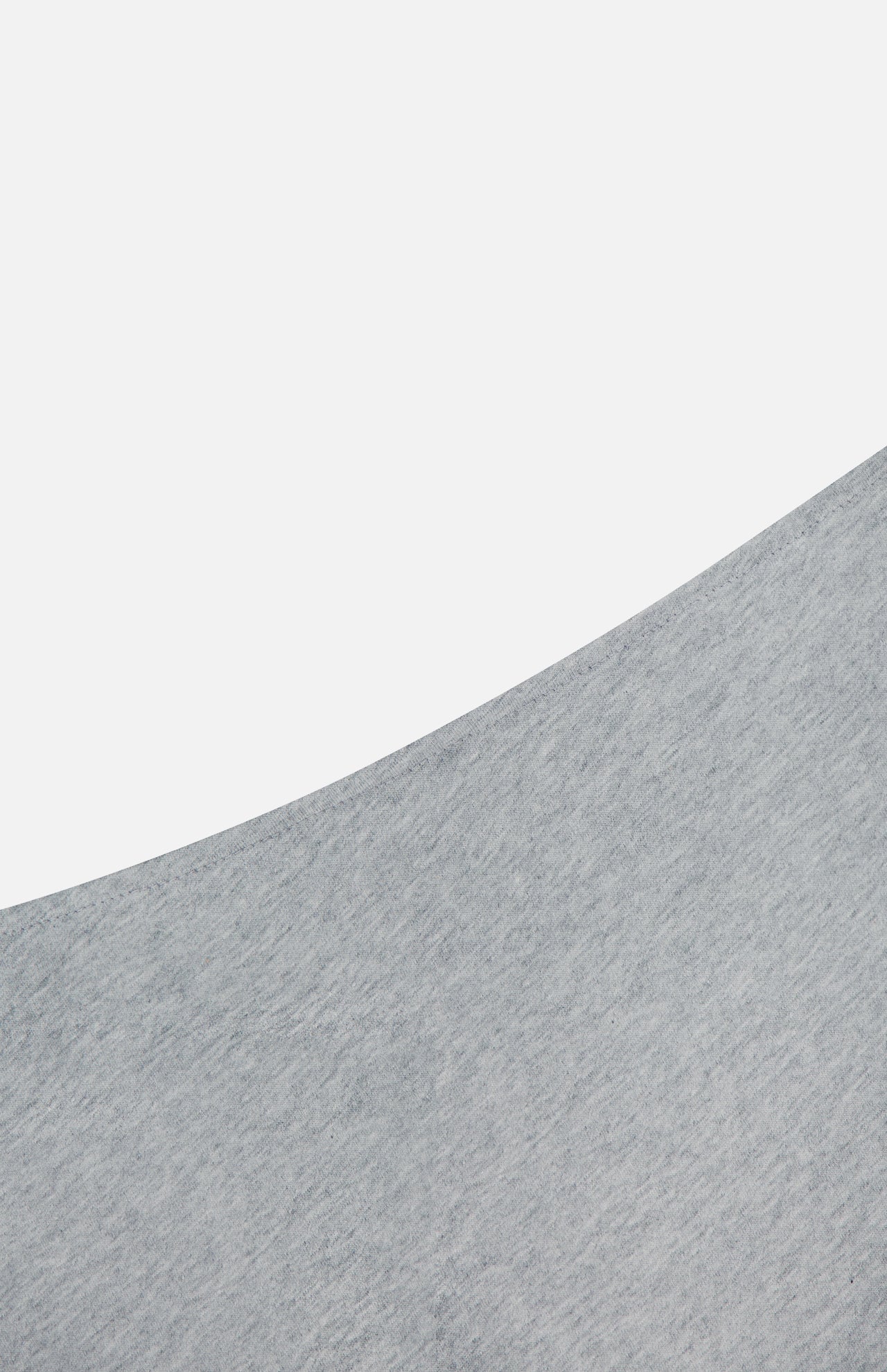 A close-up of the ARLO MOTT Beekman Maxi Skirt in pale grey, showcasing its textured fabric and mermaid hem, with the curved edge set against a plain white background.
