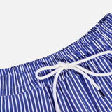 Close-up of the ARLO MOTT Gates Full Midi Skirt in blue with vertical white stripes, crafted from soft Portuguese poplin, featuring an elastic waistband with a white drawstring bow, set against a plain white background.