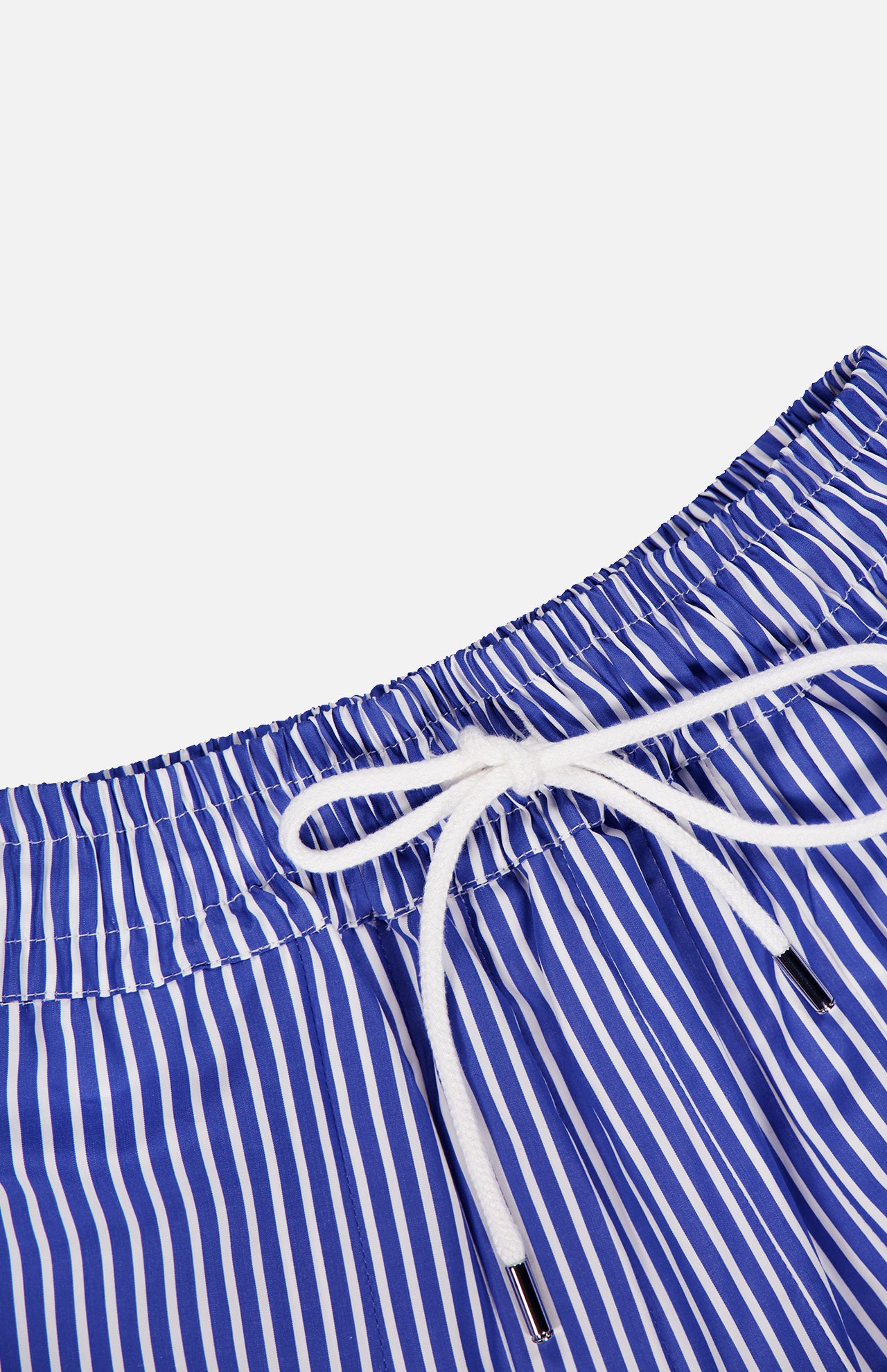 Close-up of the ARLO MOTT Gates Full Midi Skirt in blue with vertical white stripes, crafted from soft Portuguese poplin, featuring an elastic waistband with a white drawstring bow, set against a plain white background.