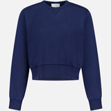 The ARLO MOTT Kent Crew Neck Snaps Sweater is a fashion-forward navy long-sleeve cropped sweatshirt with ribbed cuffs, waistband, and crew neckline, displayed on a white background.