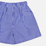 The Laight Striped Pocket Shorts by ARLO MOTT are high-rise blue striped shorts in crisp Portuguese poplin, featuring an elastic waistband and a right square pocket, shown on a white background.