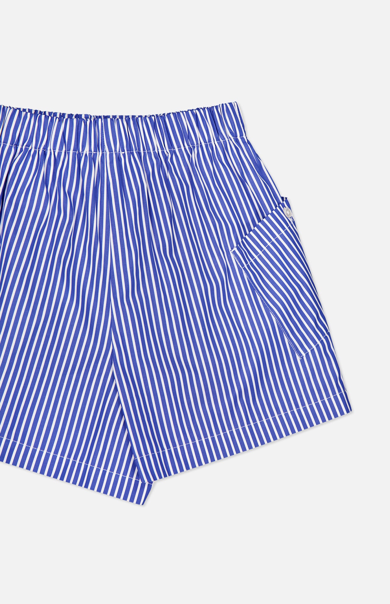 The Laight Striped Pocket Shorts by ARLO MOTT are high-rise blue striped shorts made from Portuguese poplin, featuring an elastic waistband and side pocket, shown on a white background.