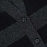 Close-up of the ARLO MOTT Lorimer Wool Cashmere Long Cardigan, showcasing its dark gray and black charcoal stripes and two black buttons. The fabric’s texture and button details are clearly visible, emphasizing the cozy feel of this oversized cardigan.