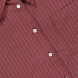 Close-up of the ARLO MOTT Webster Striped Poplin Boyfriend Shirt, featuring oxblood stripes with thin white vertical pinstripes, a pointed collar, white buttons, and a right chest pocket—an ideal choice for fall styling.