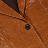 Close-up of the ARMA Aisa Lamb Nappa Print Trench Coat, featuring a rich brown faux-crocodile leather texture, two black buttons, a visible lapel, and fine stitching details.