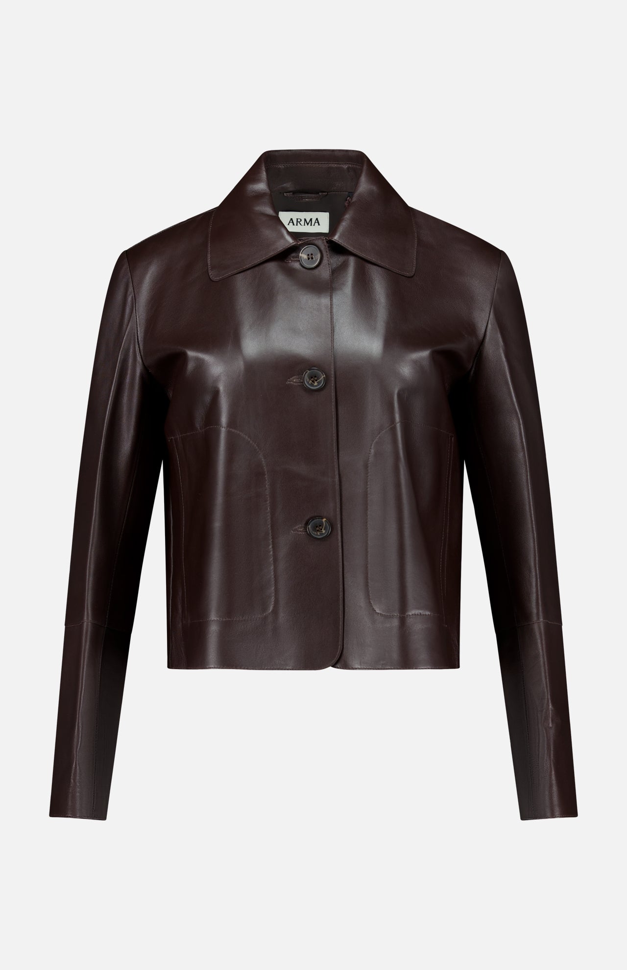 Crafted from dark brown lamb leather, the Emy Lamb Butter Coat by ARMA features a cropped, tailored silhouette with long sleeves, a collar, and three front buttons. The refined design is accented by the ARMA label visible inside the collar.