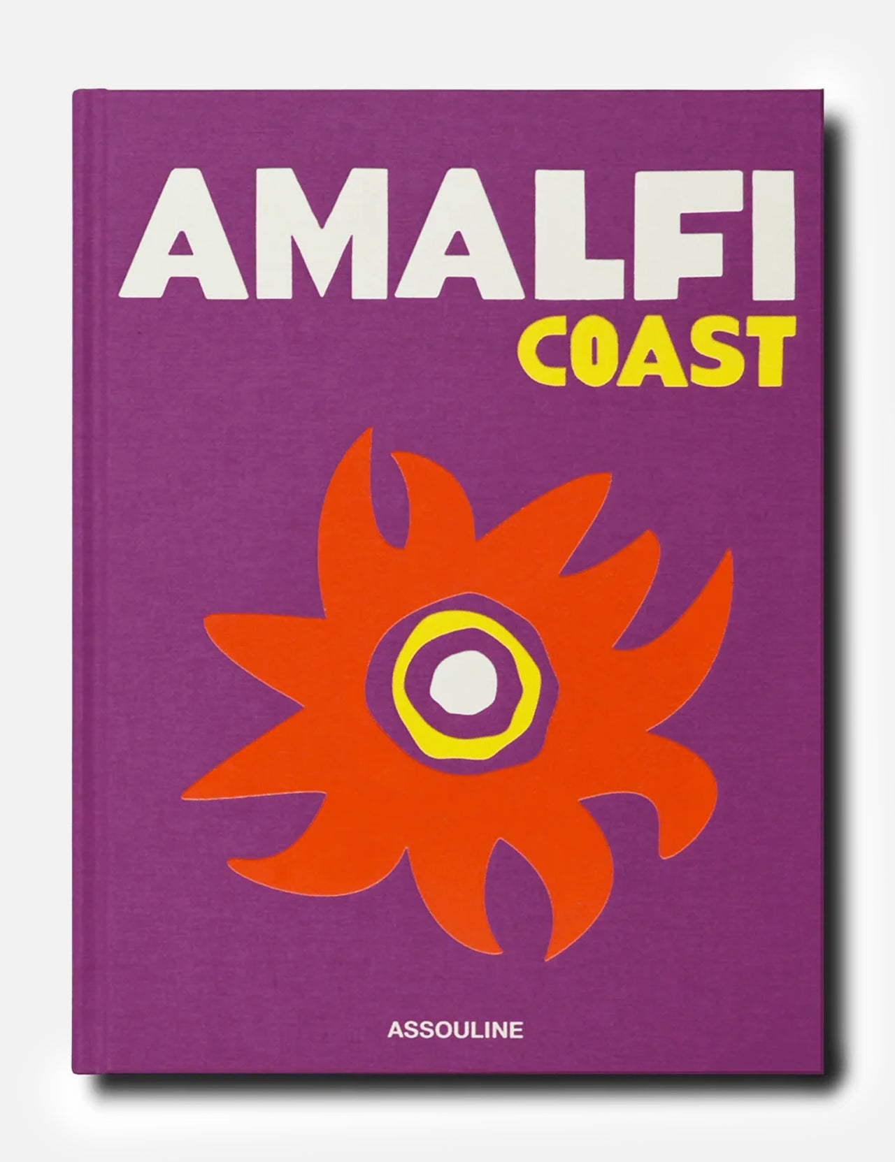 A purple book cover titled Amalfi Coast in bold white and yellow letters, adorned with an abstract orange and yellow flower design inspired by the vibrant hues of the Mediterranean Sea, published by ASSOULINE.