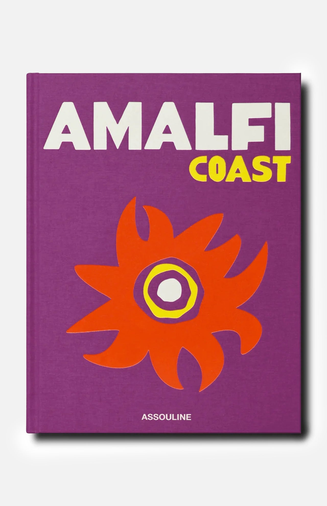 A purple book cover titled Amalfi Coast in bold white and yellow letters, adorned with an abstract orange and yellow flower design inspired by the vibrant hues of the Mediterranean Sea, published by ASSOULINE.