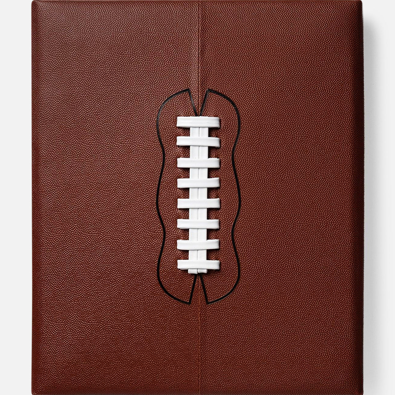 Inspired by college football and NFL history, Football: The Impossible Collection by ASSOULINE features a brown, square leather cover with a white lace cutout evoking the iconic laces of an American football.