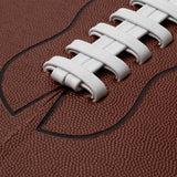 Close-up of a textured brown American football with white laces and stitched seam, as featured in ASSOULINE’s "Football: The Impossible Collection," celebrating iconic moments in NFL and college football history.