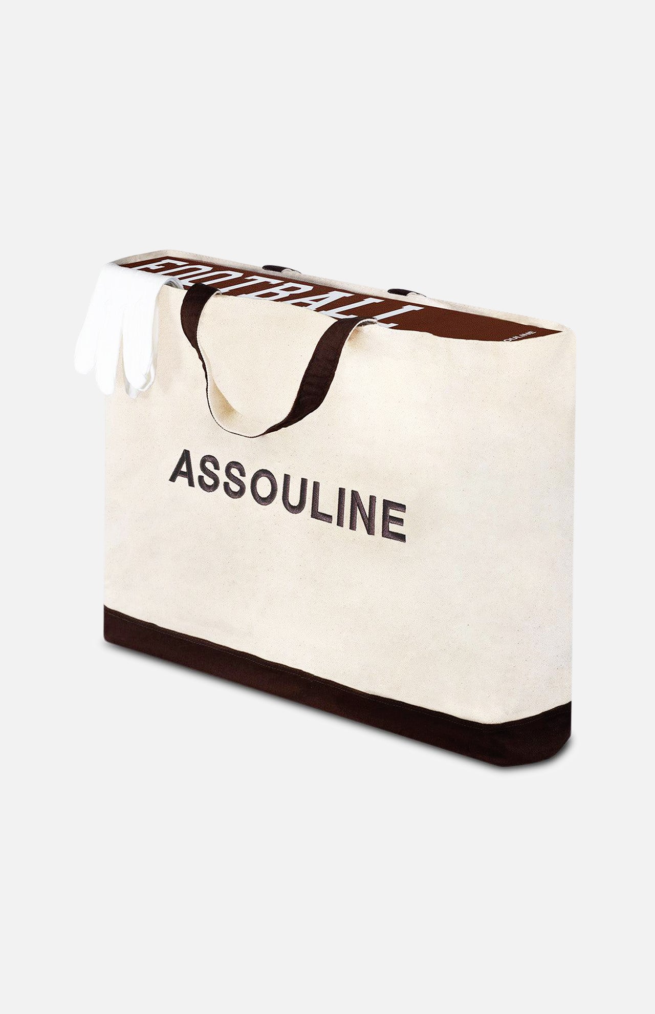 A large beige tote bag with black handles, featuring ASSOULINE printed boldly on the front. With a dark brown base and a white item inside, it's ideal for carrying the "Football: The Impossible Collection" book by ASSOULINE.
