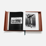 ASSOULINE's "Football: The Impossible Collection" showcases an open book in a brown case with a black-and-white group photo on the left and a vintage college football player in uniform on the right, set against a white background.