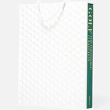 Golf: The Impossible Collection by ASSOULINE is a large white book with a textured dimpled cover, white rope handle, and green and gold spine text. Part of the Assouline Ultimate Collection.