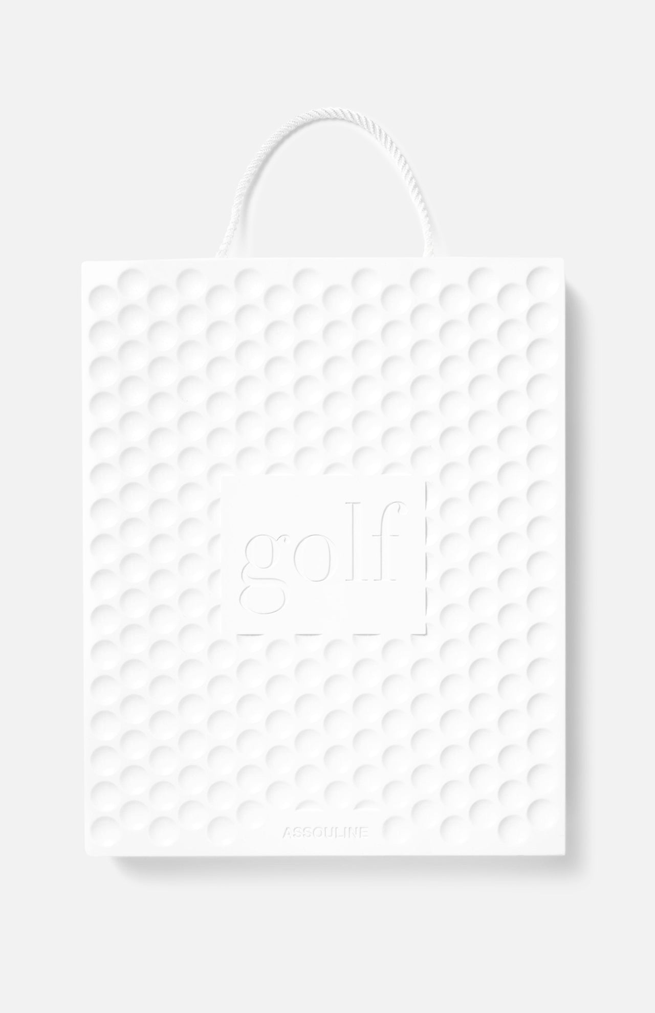 A white textured shopping bag with a golf ball pattern, rope handle, and “golf” embossed on the front celebrates ASSOULINE’s Golf: The Impossible Collection and showcases famous golf courses with the ASSOULINE brand at the bottom.