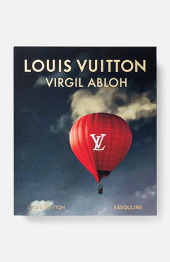 The Louis Vuitton: Virgil Abloh (Ultimate Edition) Book by ASSOULINE features a cover with a red hot air balloon adorned with a white LV logo against a cloudy sky, showcasing Virgil's visionary style and iconic sneaker collaborations.