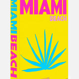 ASSOULINE’s “Miami Beach” is a bright yellow book with bold pink lettering and a blue abstract palm leaf cover design that embodies the energetic aesthetic of Art Basel Miami Beach. On the spine, “Miami Beach” appears vertically, reflecting the striking art deco style seen throughout Miami’s famous travel landmarks.