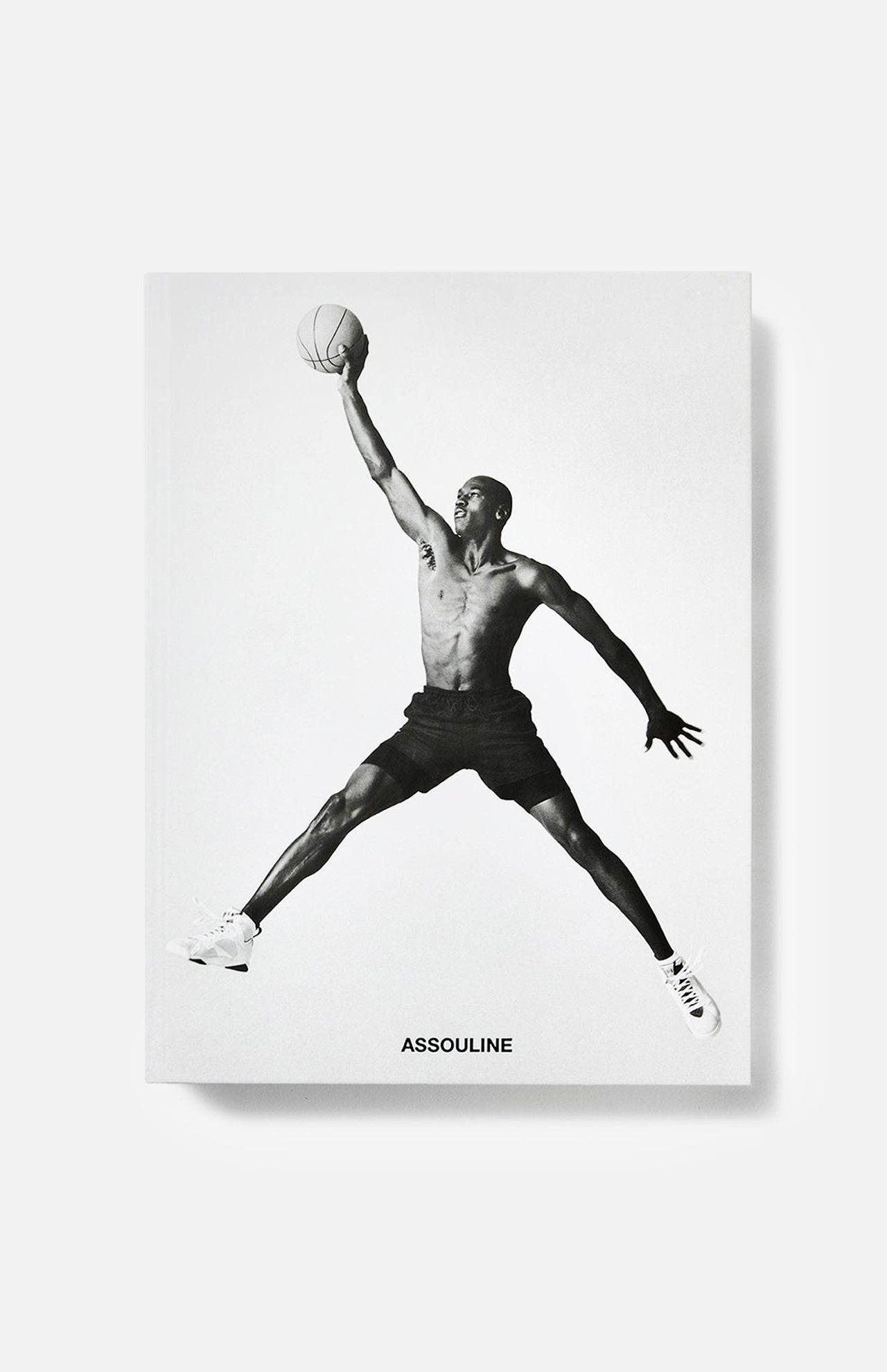 A striking black-and-white image of Michael Jordan soaring with a basketball graces the cover of the Air Jordan (Classic) Book by ASSOULINE, celebrating the legendary athlete and his iconic legacy.