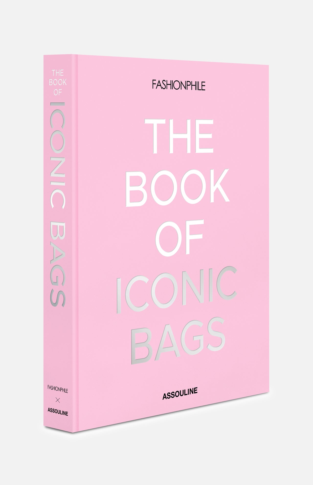 A pink hardcover, "Fashionphile: The Book of Iconic Bags" by ASSOULINE, with silver embossed text, celebrates investment handbags and luxury accessories. It stands upright against a white background.