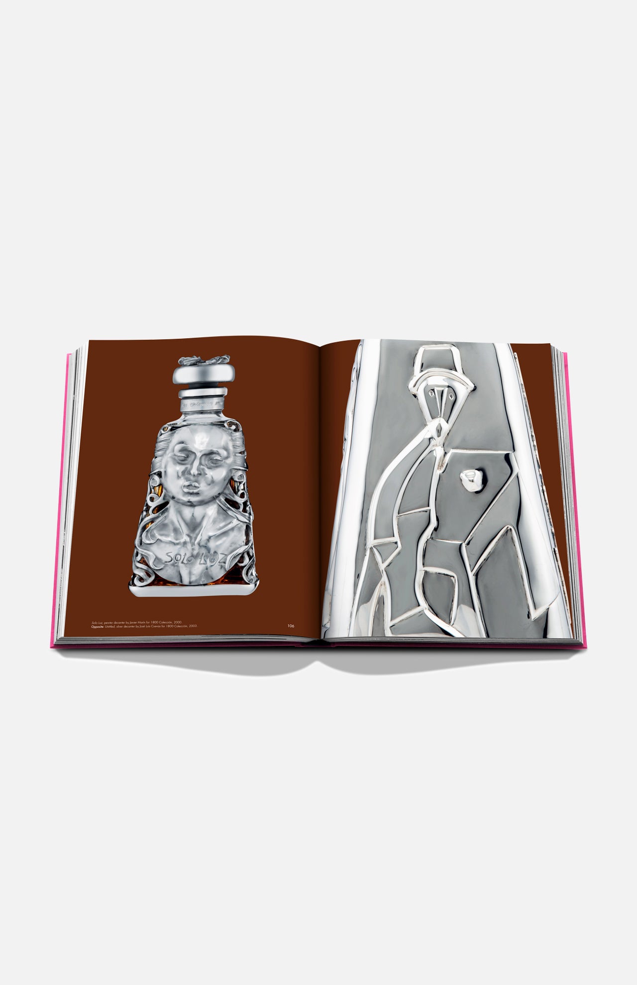An open copy of *The Art of Tequila: Spirit of Mexico Book* by Assouline shows silver decorative objects—an ornate bottle with a face on the left page and an abstract, geometric Mexican-inspired design on the right.