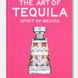The Art of Tequila: Spirit of Mexico Book by Assouline features collectible tequila bottles and Mexican art, with a drawing of a tequila bottle on a vivid pink cover.