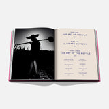 An open copy of Assouline’s The Art of Tequila: Spirit of Mexico Book displays a black-and-white photo of an agave harvester on the left and a contents page highlighting tequila history and Mexican art on the right.