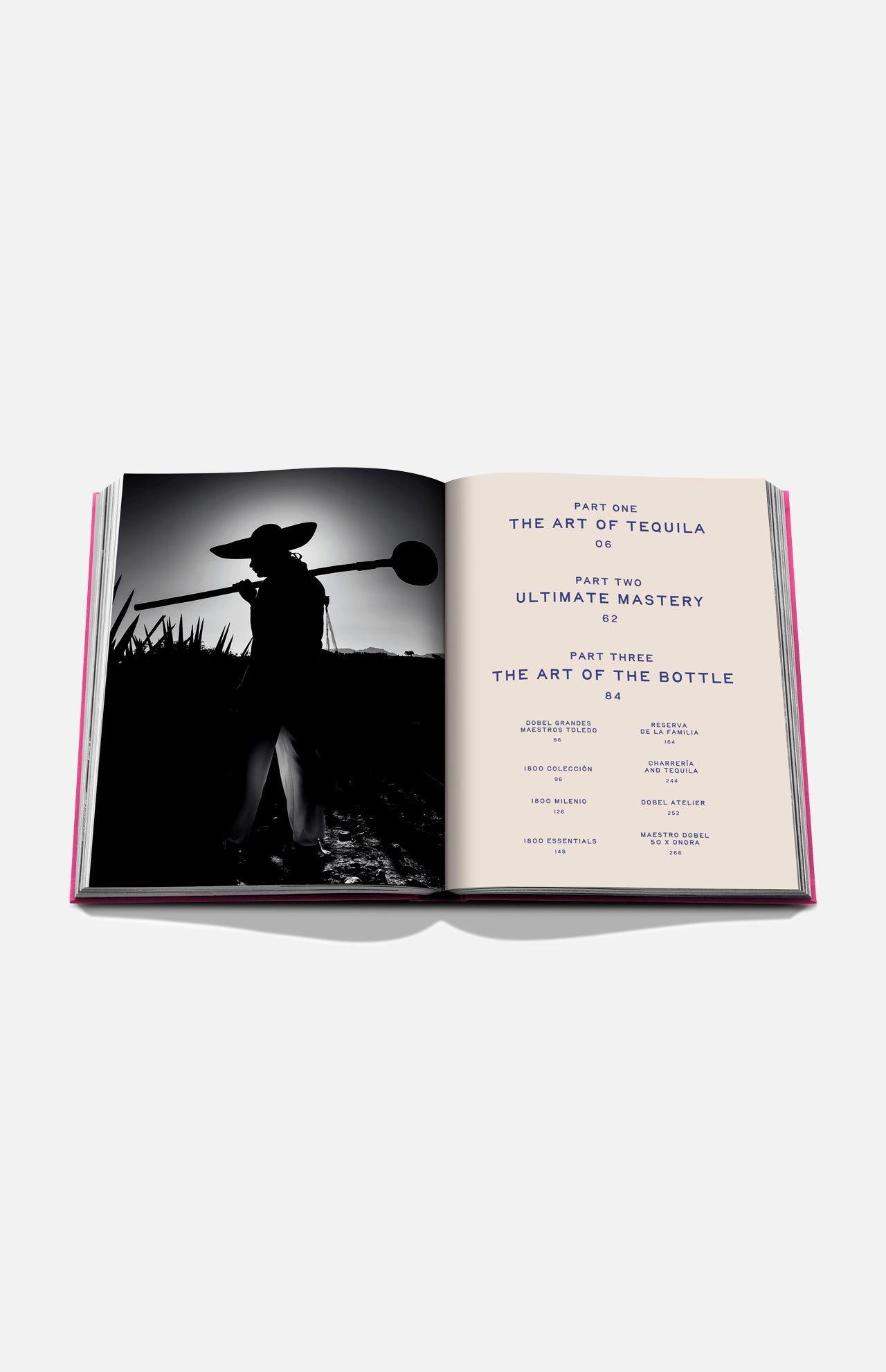 An open copy of Assouline’s The Art of Tequila: Spirit of Mexico Book displays a black-and-white photo of an agave harvester on the left and a contents page highlighting tequila history and Mexican art on the right.
