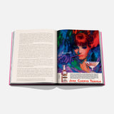 An open book, The Art of Tequila: Spirit of Mexico by Assouline, displays text on the left and a vibrant vintage tequila ad inspired by Mexican art—with a woman’s portrait, a margarita, and collectible bottles—on the right page.