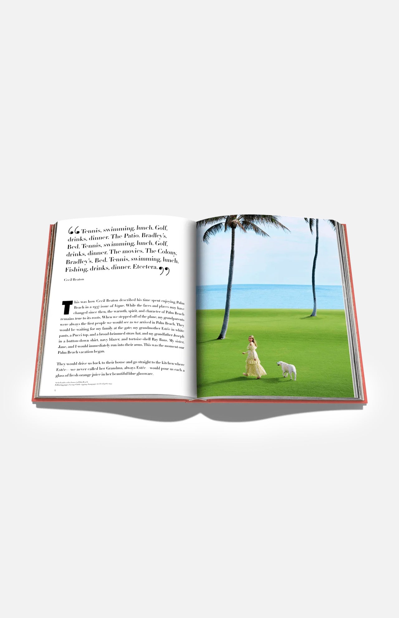 An open book from ASSOULINE titled “Palm Beach” displays text on the left page and, on the right, a photo of a woman in a long dress walking a white dog across green grass near palm trees and the ocean.