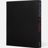 The Impossible Collection of Cars by ASSOULINE is a large black hardcover book standing upright against a plain white background, its spine featuring the title in white and red—a luxury tribute to exceptional automobiles.