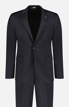 The ATELIER MUNRO Black Stretch Wool Suit is a men's formal two-piece with a single-breasted notch-lapel blazer, two buttons, flap pockets, and matching trousers, shown on a white background.
