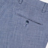 Close-up of the back pocket of light blue Melange Wool Silk and Linen Suit dress pants by ATELIER MUNRO, featuring a single button closure and waistband belt loops.