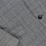 Close-up of the ATELIER MUNRO Peak Lapel Plaid Suit, featuring a gray wool fabric in black and white plaid with black buttons—perfect for formal occasions.