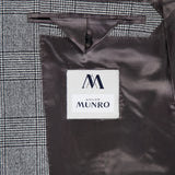 Close-up of the Peak Lapel Plaid Suit’s inner lining by ATELIER MUNRO, ideal for formal events, with a buttoned pocket and black-and-white plaid pattern paired with dark brown satin.
