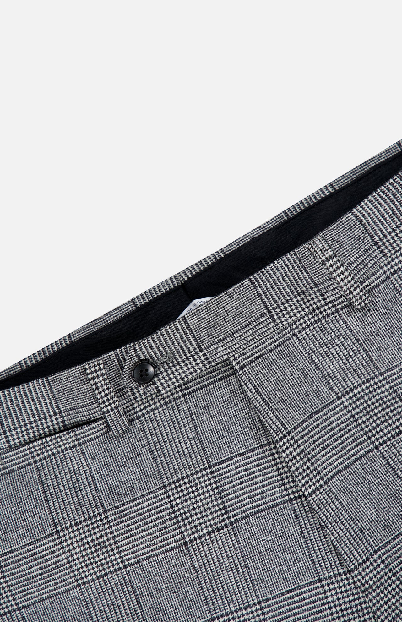 Close-up of the Peak Lapel Plaid Suit by ATELIER MUNRO, featuring gray wool fabric with black button and belt loops, ideal for formal events, shown against a white background.