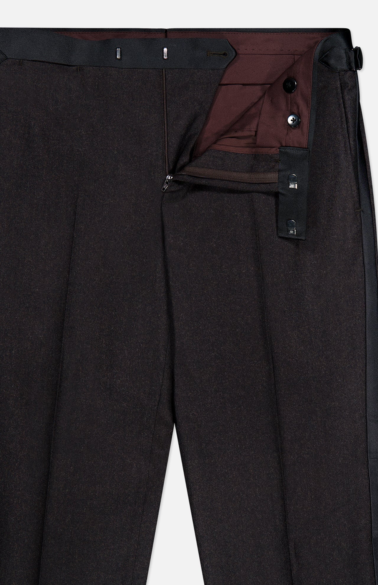 ATELIER MUNRO’s Shawl Lapel Tuxedo Suit features dark formal trousers with a partially open zipper, unbuttoned waistband with black adjusters, burgundy lining, and subtly textured pure wool fabric.