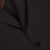 Close-up of the ATELIER MUNRO Wide Notch Lapel Solid Suit: dark brown wool blend, notched lapel, chest pocket, brown lining, and single black button—ideal for formal occasions.