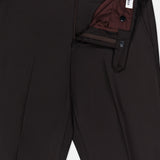 Dark brown Wide Notch Lapel Solid Suit pants by ATELIER MUNRO, shown with waistband open to reveal maroon lining and white ANTIKO label. Features belt loops, front pleats, and zipper fly with button closure.