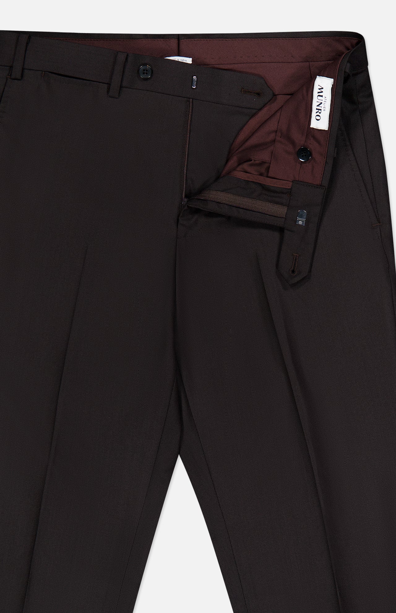 Dark brown Wide Notch Lapel Solid Suit pants by ATELIER MUNRO, shown with waistband open to reveal maroon lining and white ANTIKO label. Features belt loops, front pleats, and zipper fly with button closure.