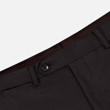 Close-up of the waistband and upper section of the Wide Notch Lapel Solid Suit by ATELIER MUNRO, featuring a black button, belt loops, front pocket seam, and burgundy lining on this wool blend suit.