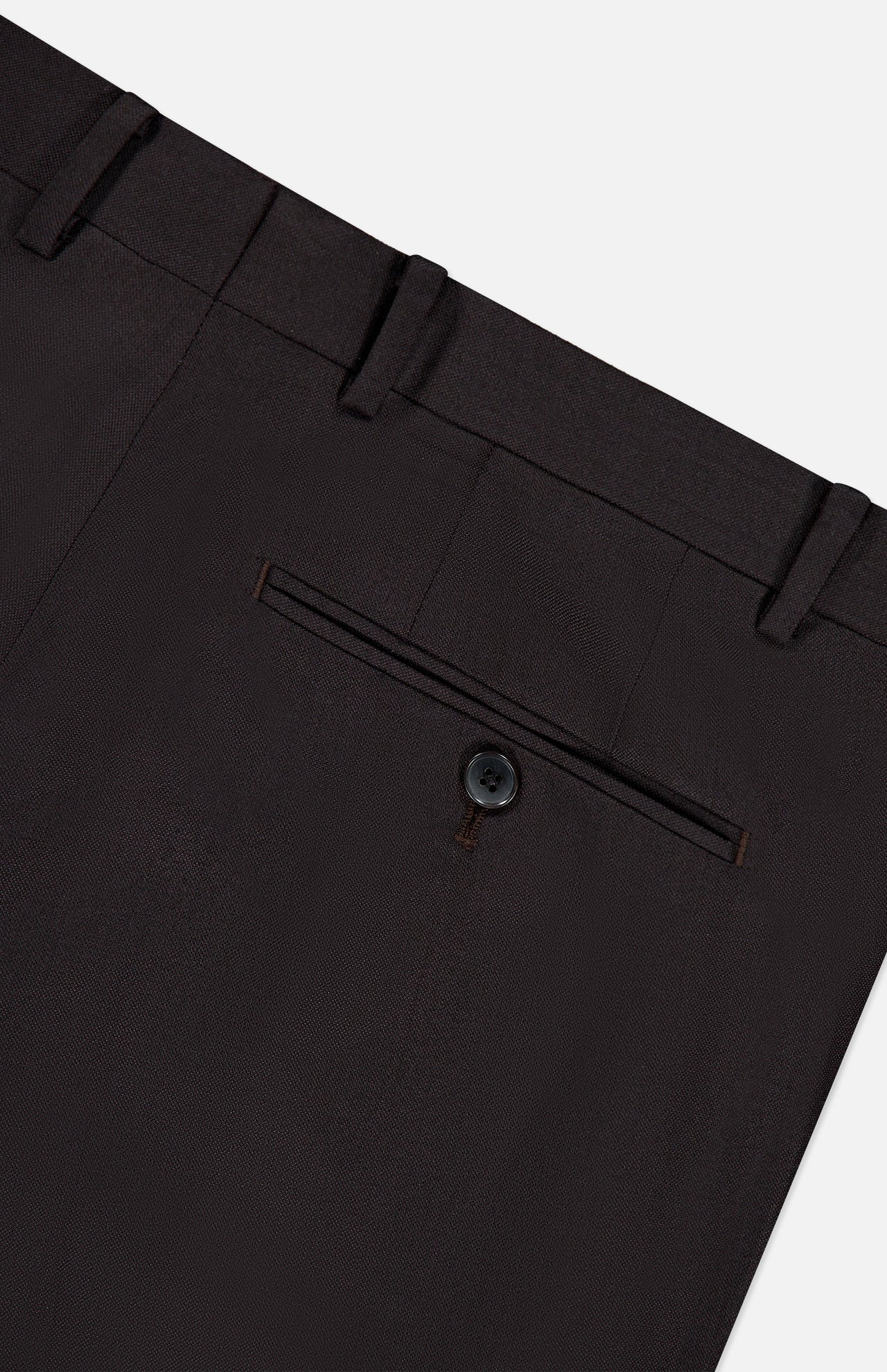 Close-up of the back pocket on the Wide Notch Lapel Solid Suit by ATELIER MUNRO, showing a single button closure and belt loops in dark brown wool blend fabric against a light gray background.