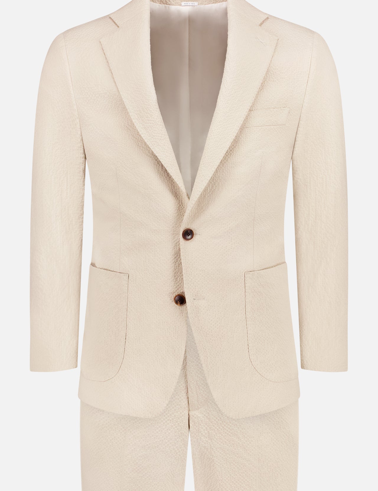 The ATELIER MUNRO Stretch Cotton Seersucker Suit in cream features a textured finish, notch lapels, two buttons, patch pockets, and a welt chest pocket. Shown against a white background.