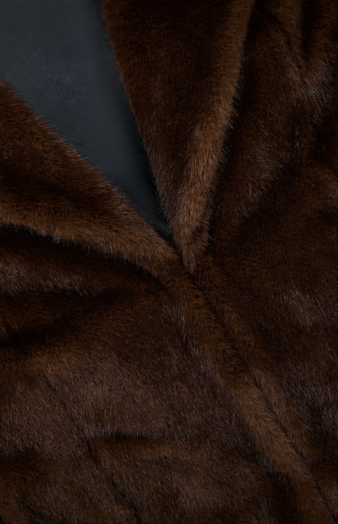 Close-up of The Mink Coat by Auter, featuring a dark brown animal-free design with a lapel and dark lining.
