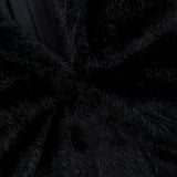 Close-up of the Auter Mink Cocoon Coat, an oversized black mink coat featuring a smooth dark lapel.